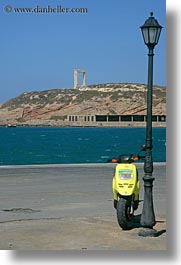 arches, colors, europe, greece, lamp posts, motorcycles, naxos, vehicles, vertical, yellow, photograph