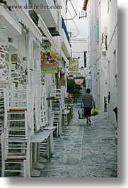 chairs, europe, greece, stacked, tinos, towns, vertical, walking, womens, photograph