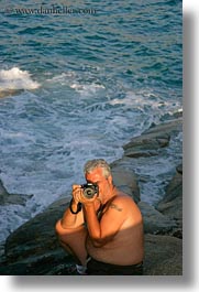 artists, cameras, emotions, europe, greece, kostas, men, ocean, people, photographers, photographing, smiles, sun, tourists, vertical, photograph