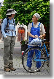 bicycles, brunette, clothes, emotions, europe, groups, hair, hats, hungary, lori, men, old, people, smiles, talking, vertical, womens, photograph