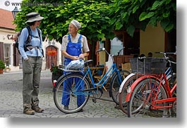 bicycles, brunette, clothes, emotions, europe, groups, hair, hats, horizontal, hungary, lori, men, old, people, smiles, talking, womens, photograph