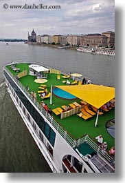 boats, budapest, buildings, cityscapes, cruise, danube, europe, hungary, riverboat cruise ship, rivers, ships, structures, umbrellas, vertical, photograph