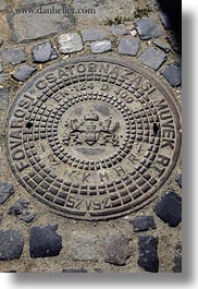 budapest, cobblestones, covers, europe, hungary, irons, manhole covers, manholes, materials, vertical, photograph