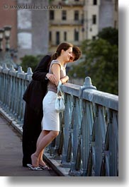 budapest, conceptual, couples, emotions, europe, hungary, looking, men, over, people, railing, romantic, smiles, vertical, womens, photograph