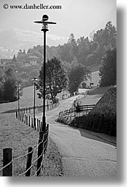 alto adige, black and white, dolomites, europe, fences, italy, lamp posts, roads, rosengarten, valley, vertical, photograph