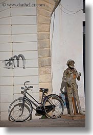 arts, bicycles, europe, italy, lecce, men, paper mache, puglia, statues, vertical, photograph