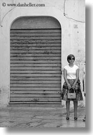 black and white, doors, europe, italy, noci, people, puglia, standing, vertical, womens, photograph