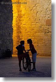 bicycles, castles, childrens, europe, evening, italy, otranto, people, puglia, vertical, photograph