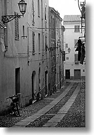 alghero, alleys, bicycles, black and white, europe, italy, sardinia, streets, vertical, photograph