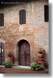 bricks, doors, europe, flowers, italy, monestaries, monte oliveto maggiore, tuscany, vertical, photograph