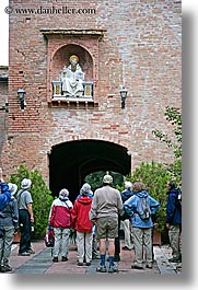 arts, bricks, europe, italy, monastery, monestaries, monte oliveto maggiore, religious, statues, tourists, tuscany, vertical, viewing, photograph
