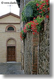 archways, cobblestones, doors, europe, flowers, italy, montalcino, stones, towns, tuscany, vertical, walls, photograph