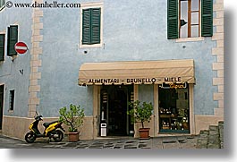 awnings, europe, general, horizontal, italy, montalcino, motorcycles, plants, stores, towns, tuscany, photograph