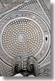 europe, feet, italy, manholes, montalcino, shoes, streets, towns, tuscany, vertical, photograph