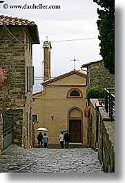 cobblestones, europe, italy, montalcino, people, streets, towns, tuscany, umbrellas, vertical, walking, photograph