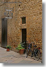 alleys, bicycles, europe, flowers, italy, pienza, plants, signs, towns, tuscany, vertical, photograph