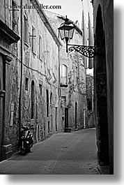 alleys, black and white, cobblestones, europe, italy, lamp posts, motorcycles, narrow streets, pitigliano, streets, towns, tuscany, vertical, photograph