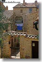 europe, hangings, italy, laundry, san quirico, stones, towns, tuscany, vertical, photograph