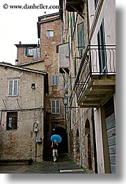 cobblestones, europe, italy, men, people, photographers, siena, towns, tuscany, umbrellas, vertical, photograph