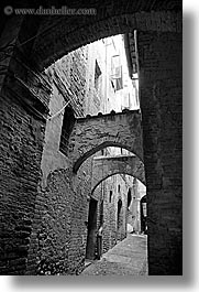 archways, black and white, bricks, cobblestones, europe, italy, narrow streets, siena, streets, towns, tuscany, vertical, photograph