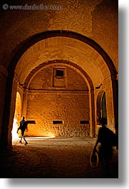 arches, archways, cobblestones, europe, fortress, italy, pedestrians, people, sorano, towns, tuscany, vertical, walking, photograph