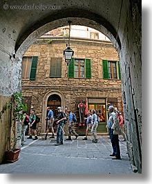 archways, europe, italy, people, sorano, tourists, towns, tuscany, under, vertical, walking, photograph