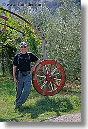 dave, europe, italy, men, thornton, tourists, tuscany, vertical, wagon wheels, photograph