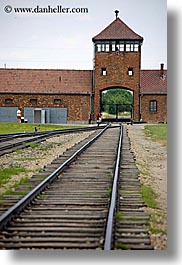 auschwitz, berkenau, bricks, buildings, europe, guard tower, materials, poland, prison, prison camp, railroad, structures, towers, tracks, vertical, photograph