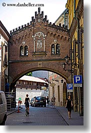 archways, bridge, buildings, europe, krakow, over, poland, streets, vertical, photograph