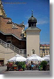 buildings, domes, europe, krakow, onions, poland, restaurants, umbrellas, vertical, photograph