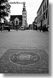 black and white, churches, covers, europe, krakow, manholes, poland, vertical, photograph