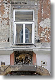 europe, krakow, lions, poland, sculptures, under, vertical, windows, photograph