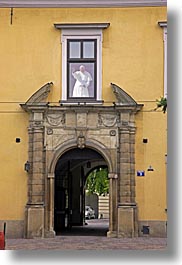 archways, christian, colors, europe, from, krakow, over, poland, popes, religious, vertical, waving, windows, yellow, photograph