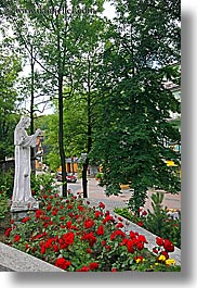 europe, flowers, poland, red, statues, vertical, zakopane, photograph