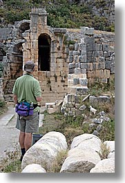 amphitheater, architectural ruins, europe, men, myra, old myra, stones, tourists, turkeys, vertical, walls, photograph