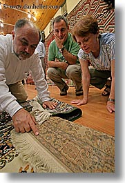 europe, examining, men, rugs, tourists, turkeys, turkmen rugs, vertical, photograph