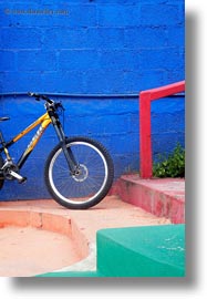 bicycles, blues, ecuador, equator, galapagos islands, latin america, puerto ayora, railing, red, santa cruz, vertical, walls, yellow, photograph
