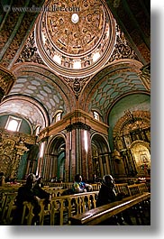 arches, archways, buildings, churches, domes, ecuador, equator, latin america, people, praying, quito, religious, structures, vertical, photograph