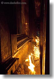 buildings, candles, catholic, churches, glow, holy sepulchre, israel, jerusalem, lamps, lights, middle east, religious, religious sites, structures, vertical, walls, photograph