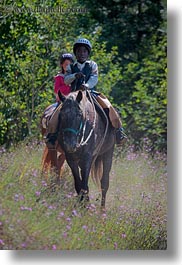 activities, america, boys, childrens, clothes, flowers, hats, helmets, horseback riding, horses, idaho, nature, north america, people, red horse mountain ranch, riding, united states, vertical, wildflowers, photograph