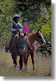 activities, america, boys, childrens, clothes, flowers, hats, helmets, horseback riding, horses, idaho, nature, north america, people, red horse mountain ranch, riding, united states, vertical, wildflowers, photograph