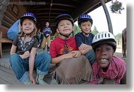 america, boys, childrens, clothes, emotions, fisheye lens, girls, happy, hats, helmets, horizontal, idaho, north america, people, red horse mountain ranch, smiles, stables, united states, photograph