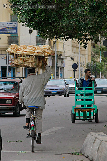 man-on-bicycle-w-bread-on-head.jpg