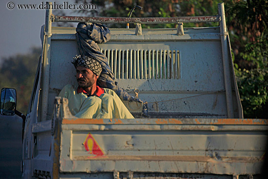 man-riding-back-on-truck.jpg