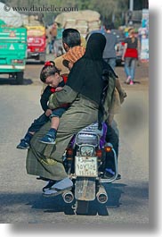 africa, burka, cairo, clothes, dresses, egypt, families, motorcyce, people, vertical, photograph
