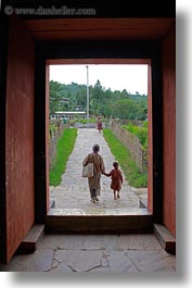 asia, asian, bhutan, buddhist, clothes, doors, mothers, people, punakha dzong, religious, robes, sons, temples, vertical, photograph