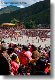 asia, asian, bhutan, buddhist, dancers, oranges, people, religious, style, tashichho dzong, vertical, photograph