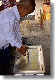 images/Asia/Cambodia/AngkorWat/People/Kids/boy-placing-money-in-box.jpg