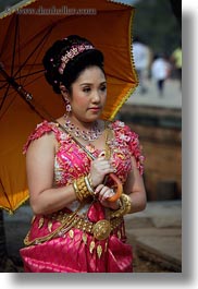 angkor wat, asia, cambodia, dresses, people, traditional, umbrellas, vertical, womens, photograph