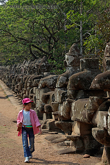 girl-in-pink-walking-by-statues-2.jpg